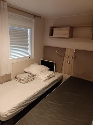 a bedroom with a bed with a laptop on it at Le petit paradis in Fréjus