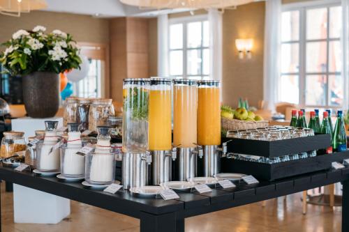 a table with glasses of juice and bottles on it at Sheraton Rome Parco de Medici in Rome