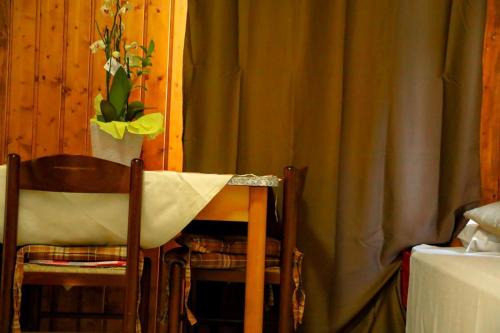 a table and two chairs and a curtain at The Courtyard Retreat in Brunate