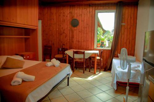 a bedroom with two beds and a table and a window at The Courtyard Retreat in Brunate