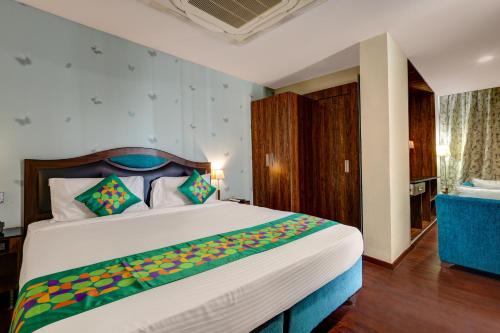 a bedroom with a large bed in a room at Treebo Blak & Wite Rk Beach in Visakhapatnam