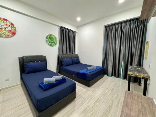 a living room with two beds and a window at SA Sutera Avenue Homestay Opposite Imago KK in Kota Kinabalu