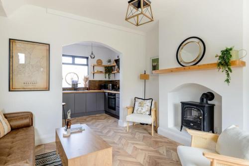 a living room with a table and a fireplace at Cottage in the City The Harland Rathdrum Cottage in Belfast