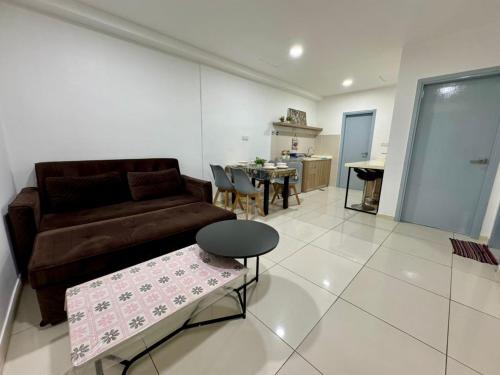 a living room with a couch and a table at SA Sutera Avenue Homestay Opposite Imago KK in Kota Kinabalu