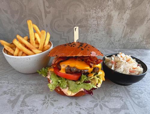 a sandwich and french fries and a bowl of coleslaw at Hotel Fabrica in Liberec