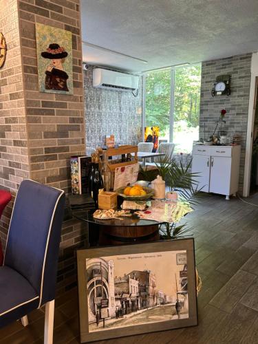 a living room with a table with food on it at Студия на двоих с потрясающим видом на море in Batumi