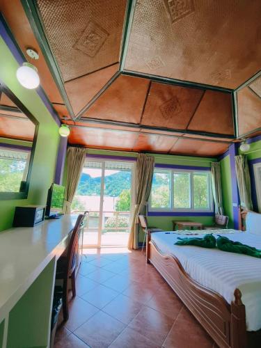 a bedroom with two beds and a large window at Phi Phi View Point Resort in Phi Phi Don