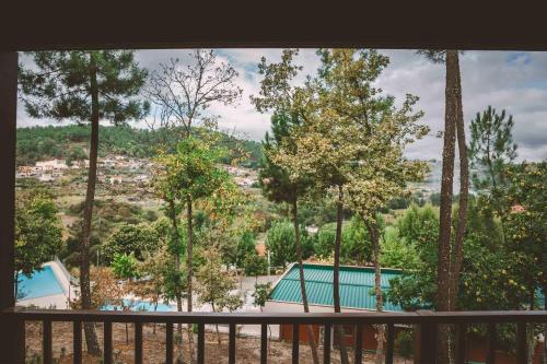 a view from the balcony of a resort with trees at Quinta do Lameiro in Tarouca