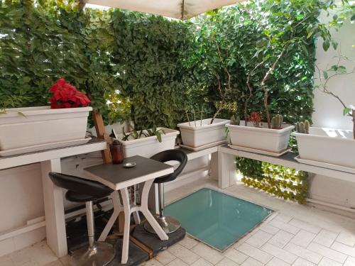 a patio with a table and potted plants at Suite vecchia Dante in Bari