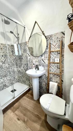 a bathroom with a sink and a shower and a toilet at Zahora Beach Room in Zahora