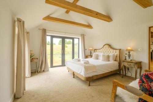 a bedroom with a bed and a large window at Sandown in Snape