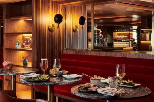 a restaurant with two tables with plates of food at Melia White House Hotel in London