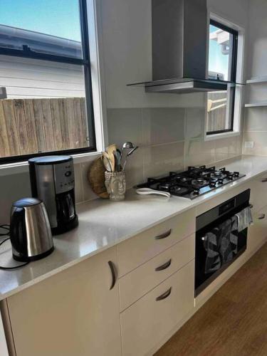 a kitchen with a stove and a counter top at Casual comfort in Byron Shire in Mullumbimby