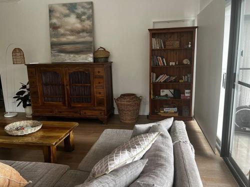 a living room with a couch and a table at Casual comfort in Byron Shire in Mullumbimby