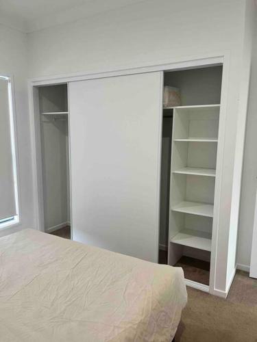 a bedroom with a bed and an empty closet at Casual comfort in Byron Shire in Mullumbimby