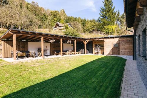 a house with a large lawn in front of it at Apartmány pri Jaskyni - Bystrá in Bystrá