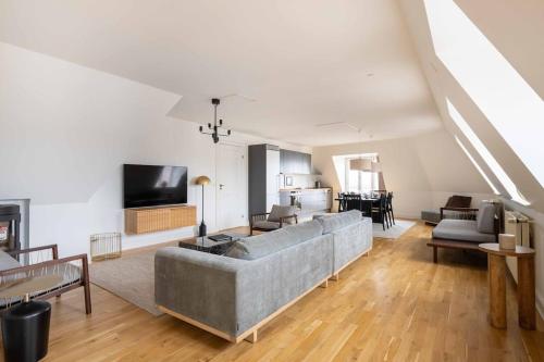a living room with a couch and a tv at 2BR with Amazing City Skyline View in Copenhagen