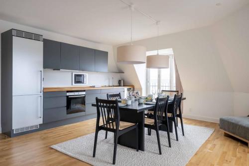 a kitchen and dining room with a table and chairs at 2BR with Amazing City Skyline View in Copenhagen