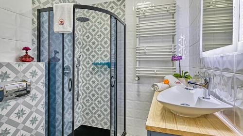 a bathroom with a sink and a shower at Apartament Podróżniczy z prywatną Sauną blisko Elementsa - 5D Apartments in Świeradów-Zdrój