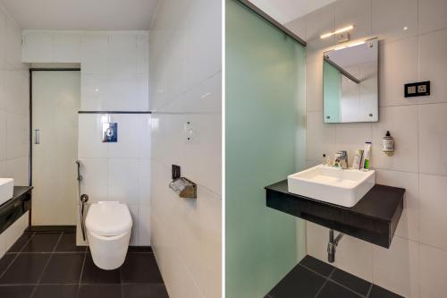 a bathroom with a toilet and a sink at Treebo Blak & Wite Rk Beach in Visakhapatnam
