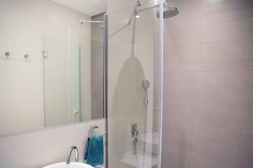 a shower with a glass door in a bathroom at Hostel Karavan Inn in Belgrade