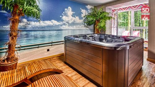 a bath tub in a room with a view of the ocean at Apartament SPA 56 Resort Kozubnik blisko Szczyrk - 5D Apartamenty in Porąbka