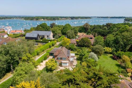 an aerial view of a large house with a river at Oldfield Cottage within walking distance of pub and sea in West Itchenor