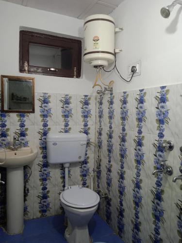 a bathroom with a toilet and a sink at Anchal House in Dharamshala
