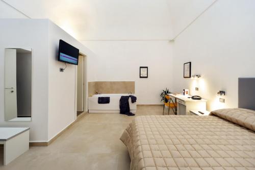 a bedroom with a bed and a bathroom with a tub at Il Tesoro Smart Suite & SPA in Naples