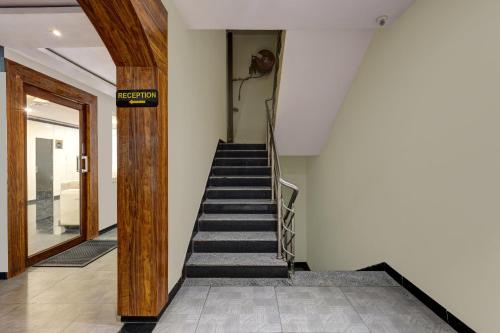 a staircase leading up to a building with a door at Treebo Blak & Wite Rk Beach in Visakhapatnam