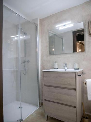 a bathroom with a shower and a sink and a mirror at AbenRazin Turístico Guadalaviar in Albarracín