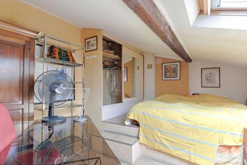 a bedroom with a bed and a fan on a glass table at Les bamboos de Malakoff Paris in Malakoff