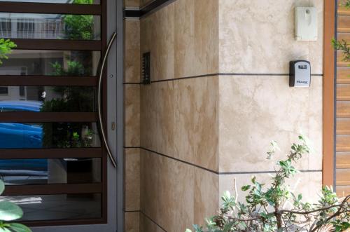 a facade of a house with a glass door at Thess1home Mistral in Thessaloniki