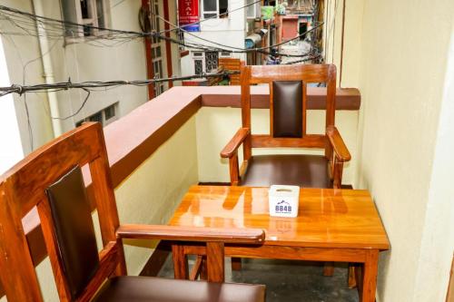 a table and two chairs sitting on a balcony at Thani Boutique Hotel in Kathmandu