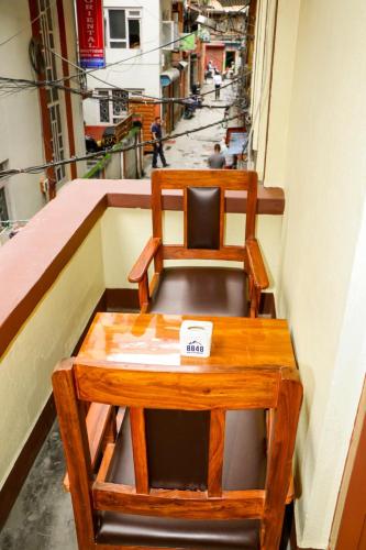 a wooden chair sitting on top of a balcony at Thani Boutique Hotel in Kathmandu