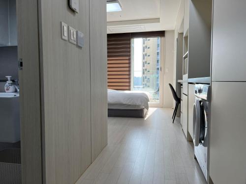 a room with a bedroom with a bed and a window at The Time hotel Incheon Airport in Incheon