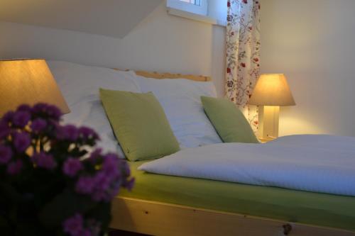 a bedroom with a bed and flowers in the foreground at Apartment Brusinka in Kašperské Hory