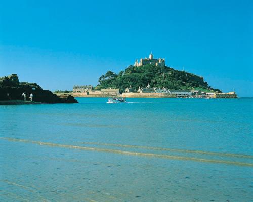 a castle on top of an island in the water at Tehidy Holiday Park in Illogan