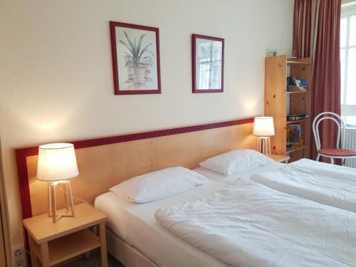 ein Hotelzimmer mit zwei Betten und zwei Lampen in der Unterkunft 2 Raum Wohnung Morgensonne mit Balkon in Ostseebad Sellin