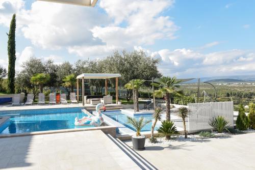 a swimming pool with a pool noodle in a resort at Villa VAND Paradiso in Međugorje