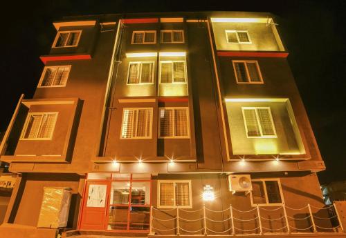 a tall building with lights on it at night at Townhouse Sarvar Hospitality Near Ascendas Park Square Mall in Bengaluru