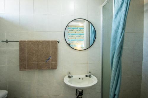 a bathroom with a sink and a mirror at Seagull 401 in Margate