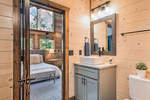 a bathroom with a sink and a mirror at Family Getaway, Hot Tub, Firepit! in Broken Bow