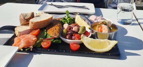 a tray with a plate of food on a table at Tehidy Holiday Park in Illogan