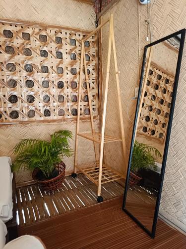 a room with a wall filled with wine bottles at Bucana Beach House North El Nido in El Nido