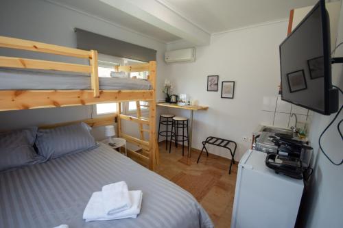 a bedroom with a bunk bed and a desk at Birdhouse Apartment Athens in Athens