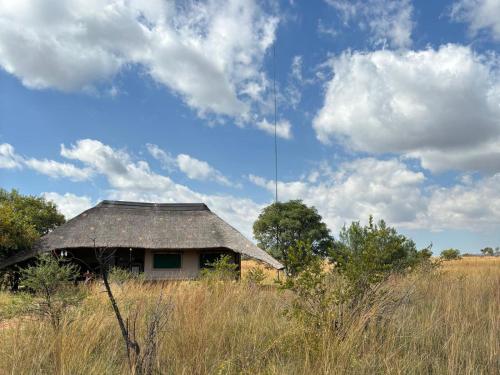 an old house in the middle of a field at Butjani Lodge in Cullinan