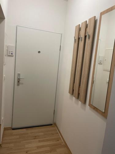 a white room with a door and a mirror at Gemütliches City Apartment in Recklinghausen