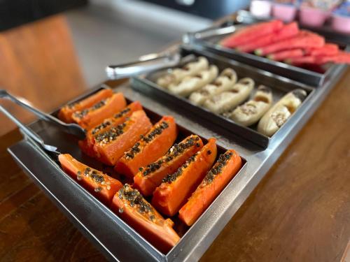 a tray of hot dogs and other foods on a table at Escarpas Styles Hotel in Capitólio