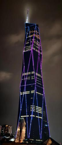 a tall building with blue lights on it at B Hotel Kuala Lumpur in Kuala Lumpur
